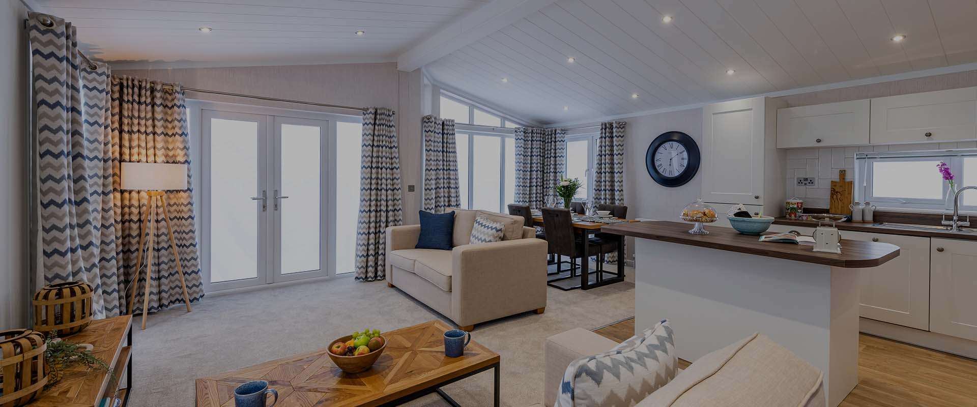 Open-plan lounge and kitchen inside a luxury lodge at Atlantic Bays Holiday Park, Padstow