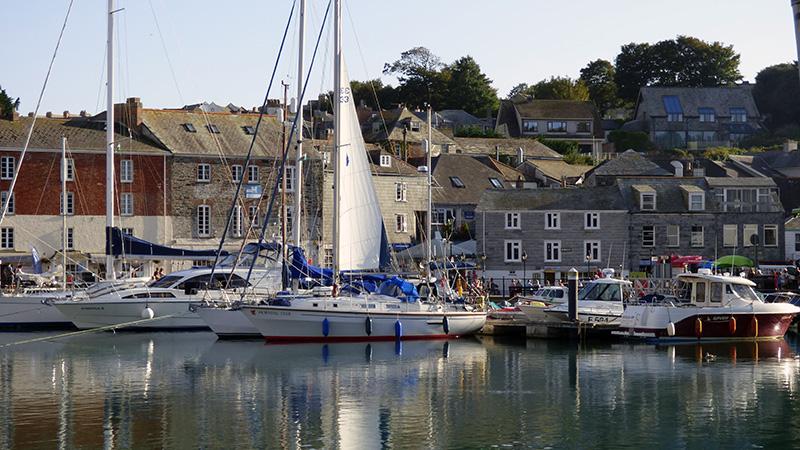 Padstow harbour with moored fishing boats and harbourside buildings, North Cornwall
