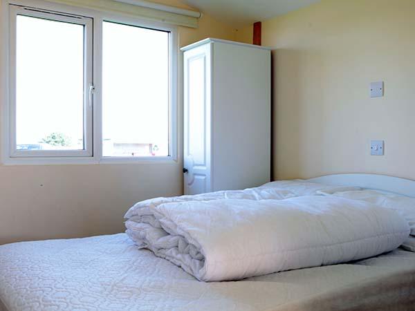 Bedroom inside a Sun Cabin chalet at Atlantic Bays, St Merryn