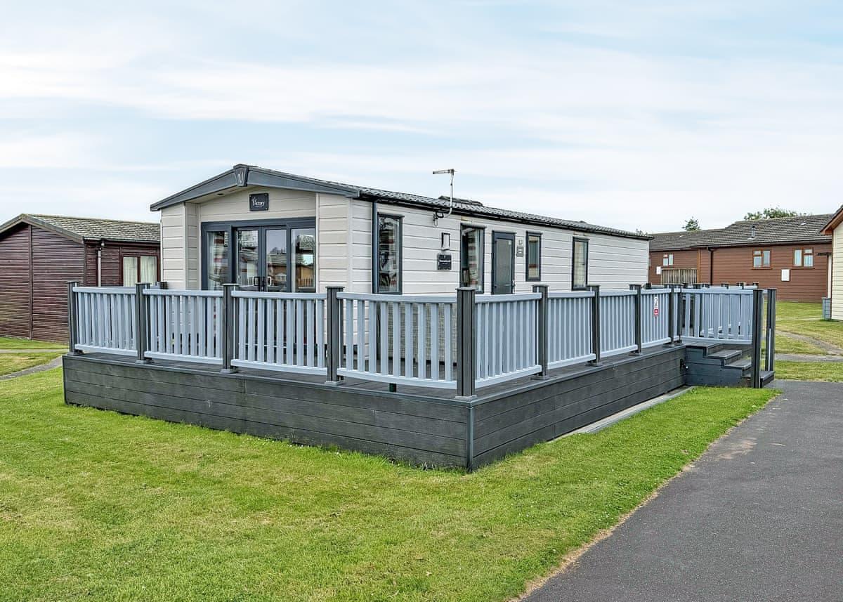 Victory St Merryn lodge exterior with raised decking at Atlantic Bays, Padstow