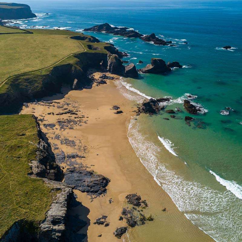 Golden sandy surf beach with turquoise Atlantic water on the North Cornwall coast near Padstow