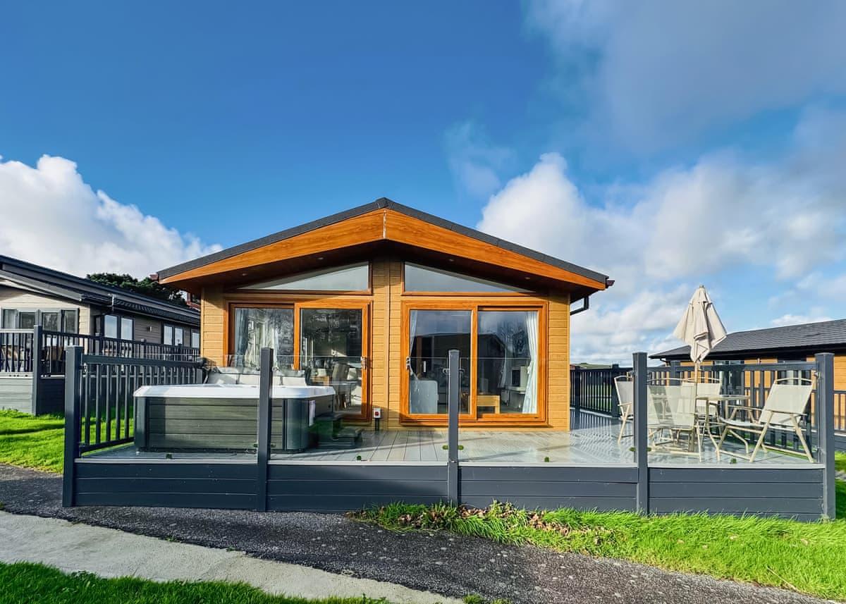 Timber-clad holiday lodge exterior at Atlantic Bays, St Merryn